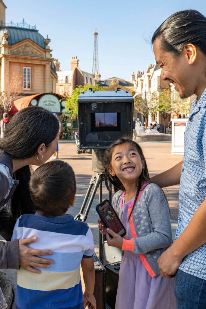 Photo of a family of 4 playing the DuckTales World Showcase Scavenger Hunt.