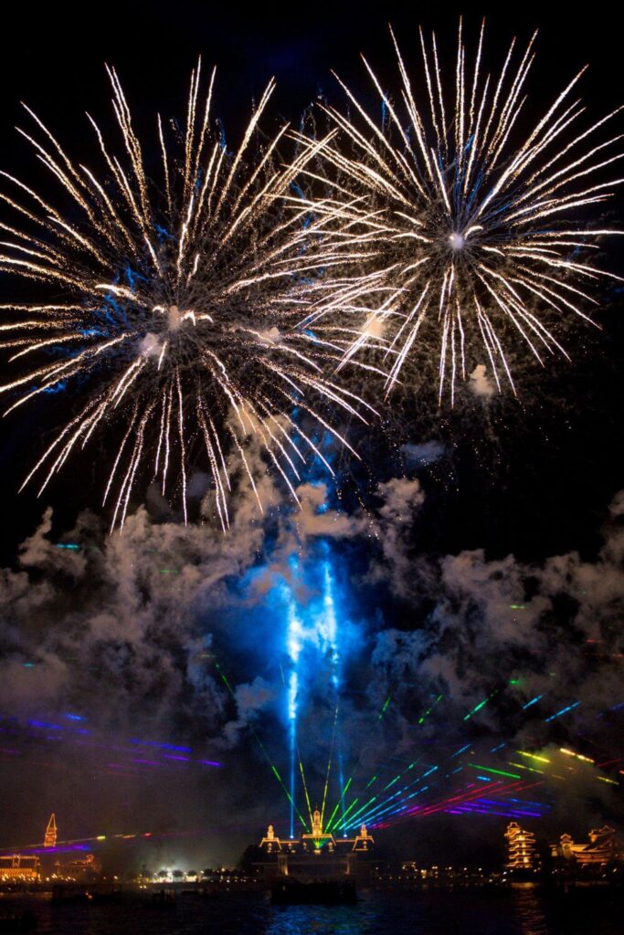 Photo of the Epcot Forever nighttime show with fireworks exploding over the lagoon.