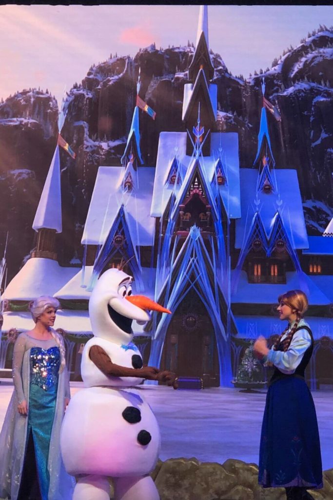 Photo of Queen Elsa, Olaf, and Anna in the stage show For the First Time in Forever: A Frozen Sing-Along at Hollywood Studios.