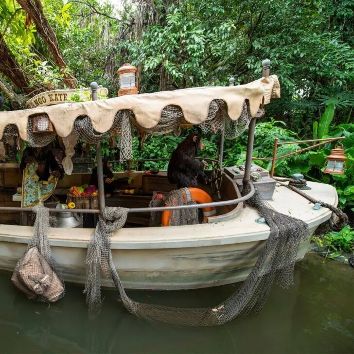 Photo of a boat overrun by faux monkeys on the Jungle Cruise ride.