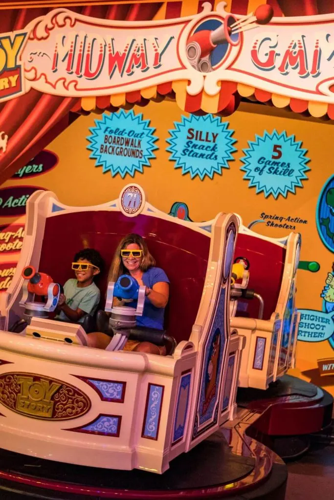 Photo of a woman and young boy playing Toy Story Mania at Hollywood Studios' Toy Story Land.