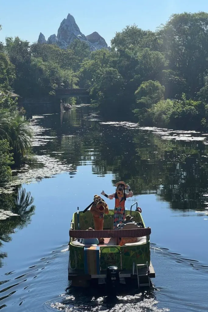 Photo of a character flotilla on the Discovery River at Animal Kingdom with Goofy and Pluto.