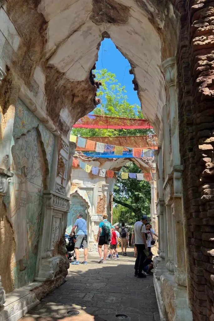 Photo looking through an archway toward Nepalese Prayer Flags strung up at Disney's Animal Kingdom Asia section.