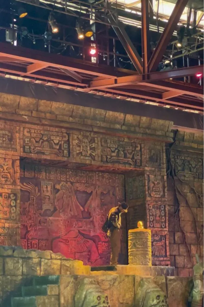 Photo of the opening scene from the Indiana Jones Epic Stunt Spectacular show. Indiana Jones is examining a relic on a pedestal.