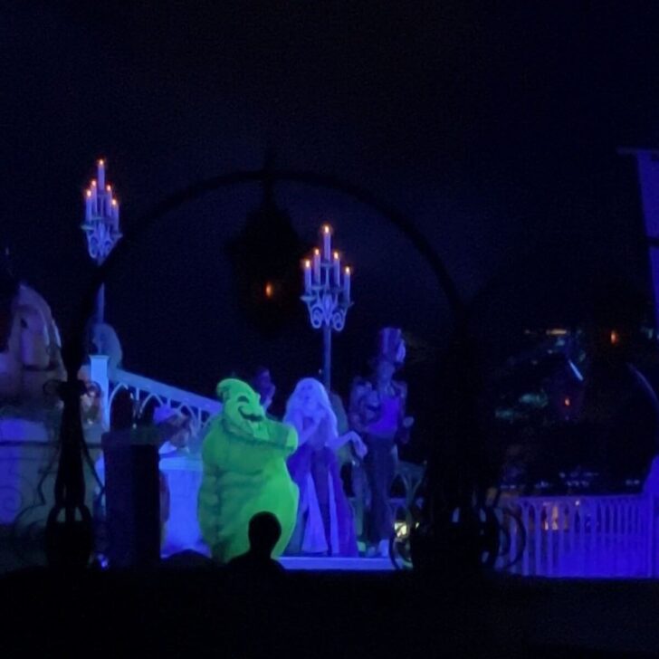 Photo of Oogie Boogie, Dr. Facilier, and the Sanderson Sisters performing on stage in the Hocus Pocus Villain Spelltacular show.