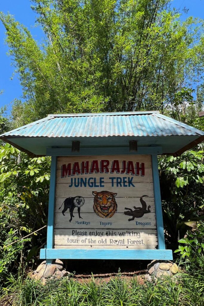 Photo of the signage for the Maharajah Jungle Trek at Animal Kingdom with a monkey, tiger, and Komodo dragon on it.