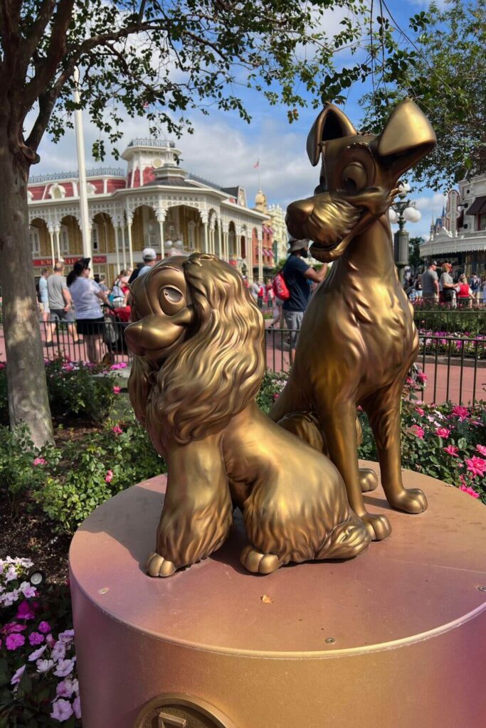 Photo of a golden statue of Lady & the Tramp in Magic Kingdom's Main Street USA area.