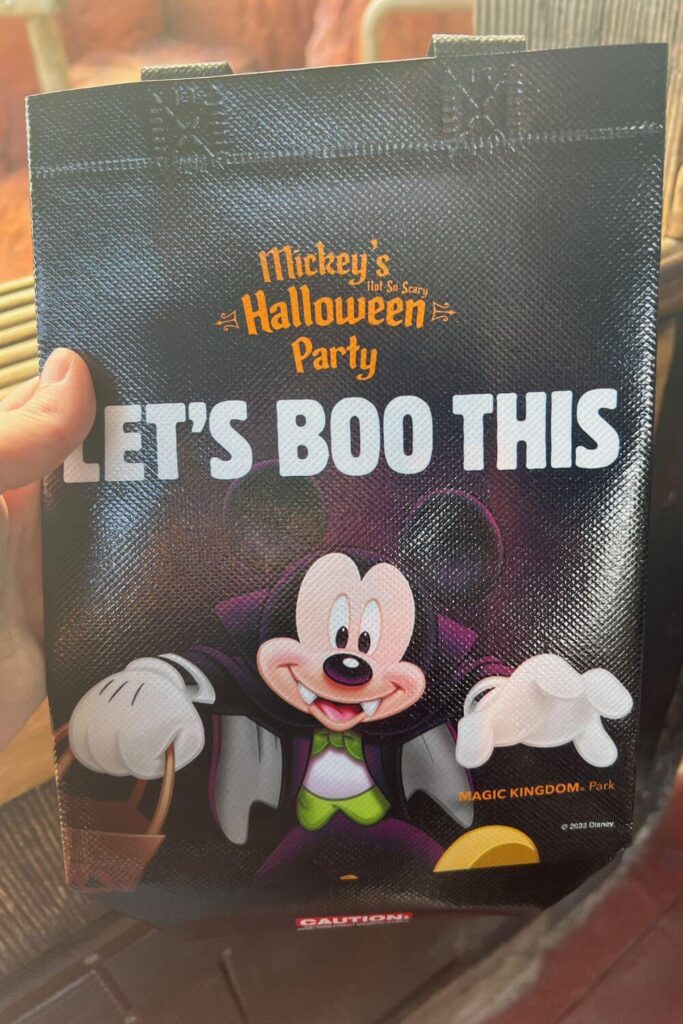 Photo of one side of the MNSSHP Trick-or-Treat Bag with vampire Mickey Mouse that says "Let's Boo This"
