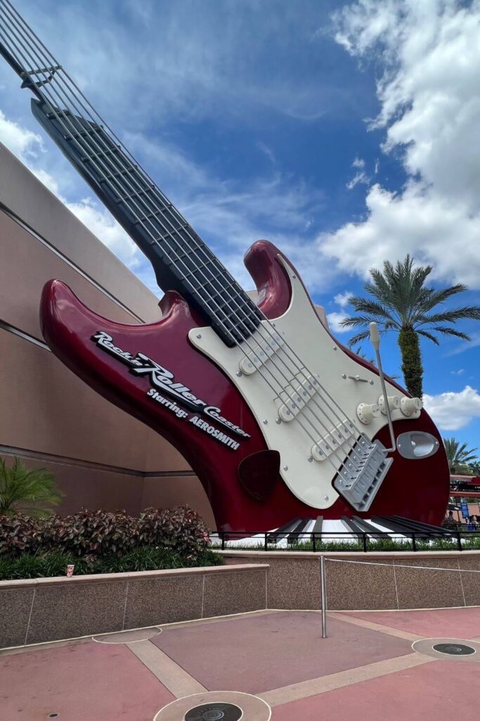 Photo of the entrance to Rock 'n' Roller Coaster with a giant red electric guitar.