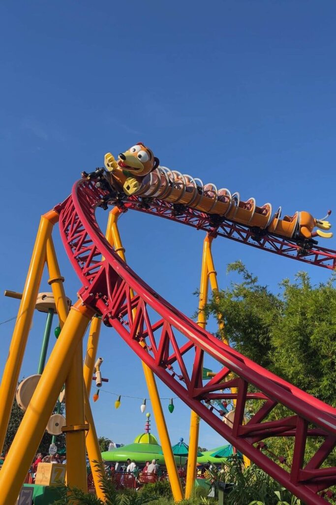 Photo of the Slinky Dog Dash roller coaster, with a slinky dog car approaching a downhill section.