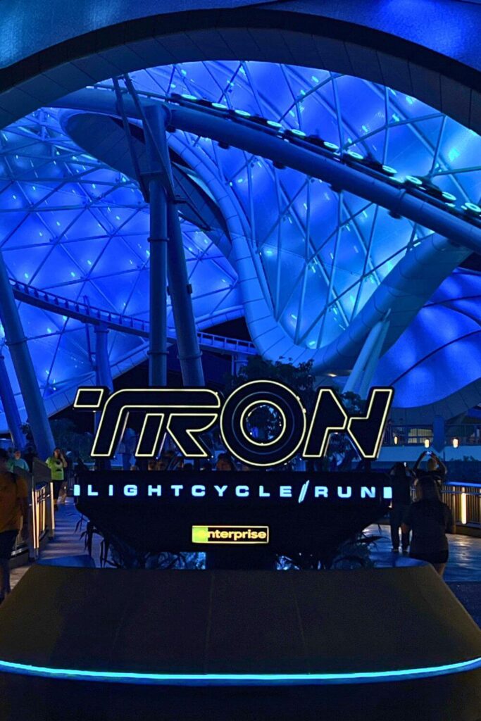 Photo of the entrance for TRON Lightcycle/Run at night with everything lit up in blue.