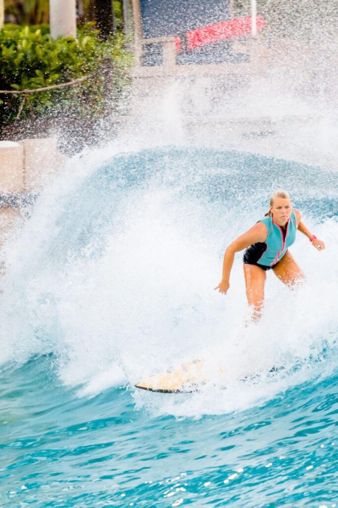 Photo of a woman surfing at Typhoon Lagoon water park at Disney World.