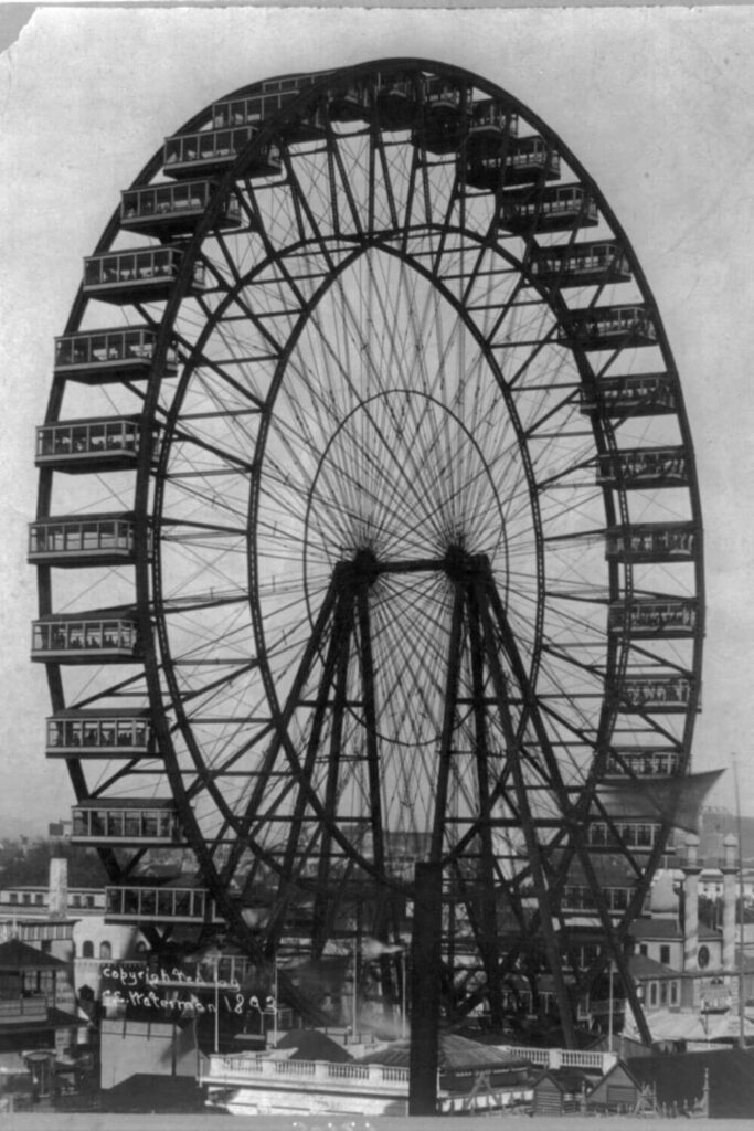 Archival photo in black and white of the first ever ferris wheel at the 1893 Chicago World's Fair.