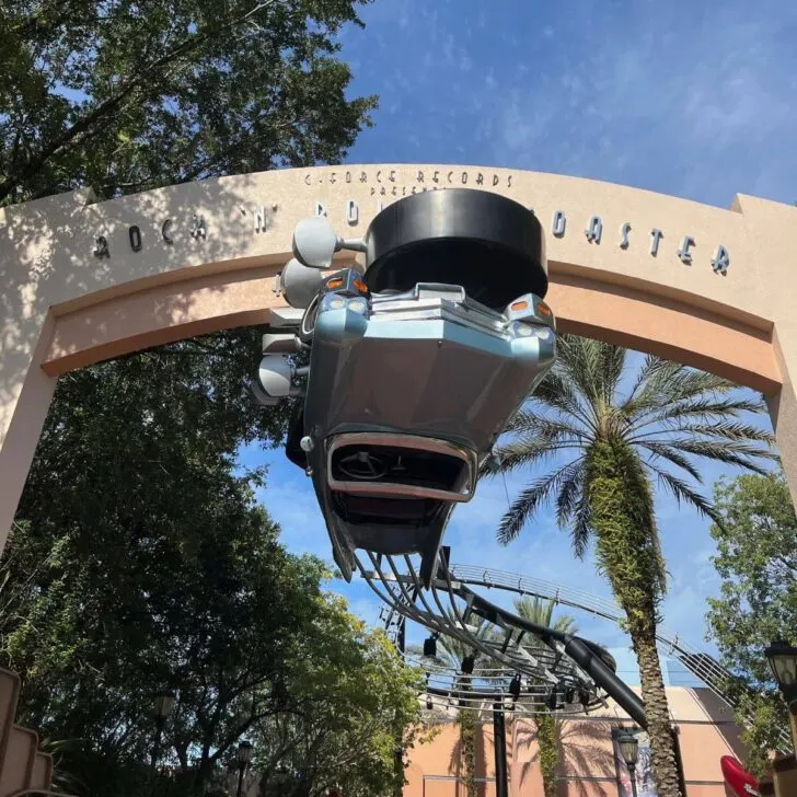 Photo of the entrance to the area where Rock n Roller Coaster is located at Hollywood Studios, featuring an upside down convertible limousine.