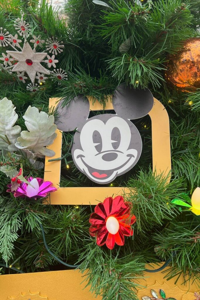 Closeup of an Annual Passholder magnet ornament on a Christmas tree.