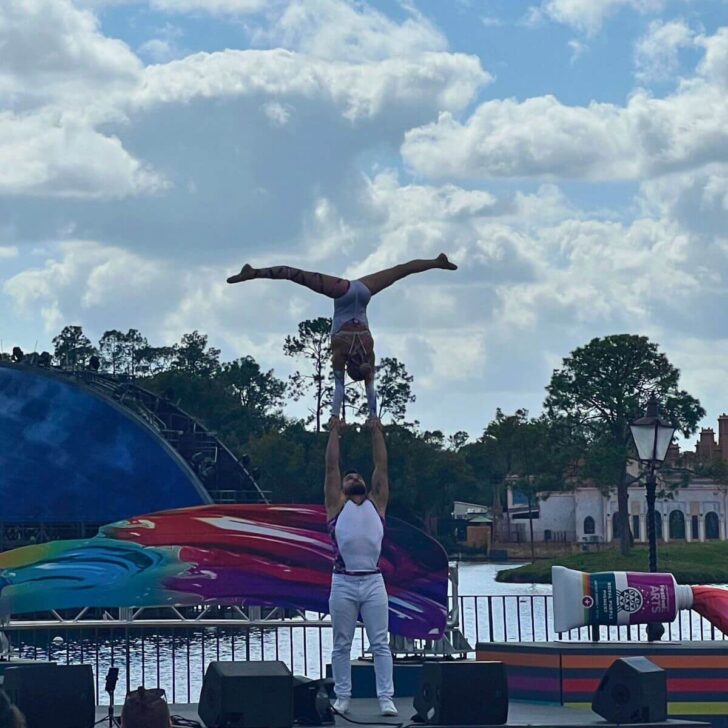 Photo of two acrobats performing on a stage in the World Showcase plaza at Epcot.