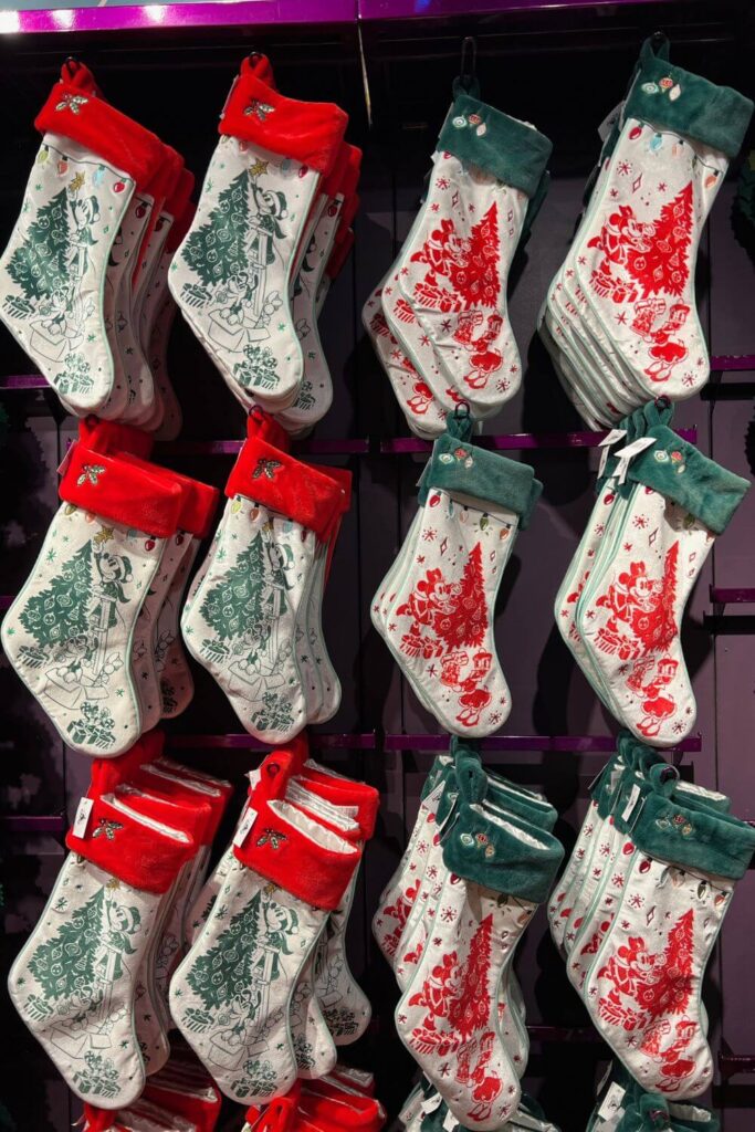 Photo of a wall of red and green Christmas stockings for sale at Disney's Days of Christmas store in Disney Springs.