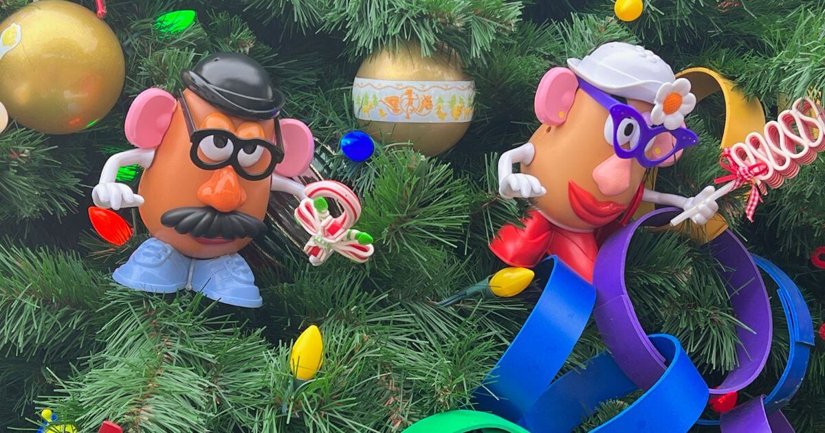 Closeup of Mr. and Mrs. Potato Head ornaments on a tree on the Disney Springs Christmas Tree Trail in Walt Disney World.