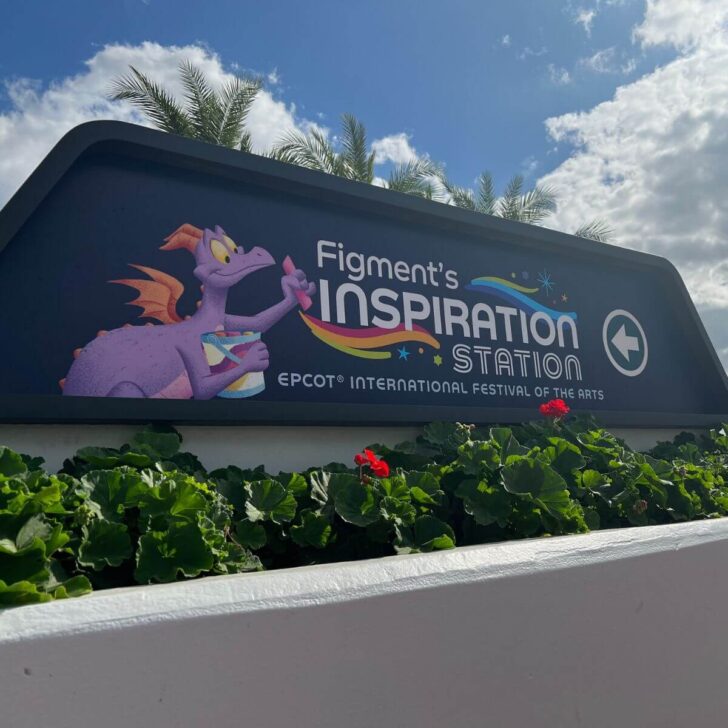 Photo of signage for Figment's Inspiration Station at Epcot, with an image of Figment the purple dragon.