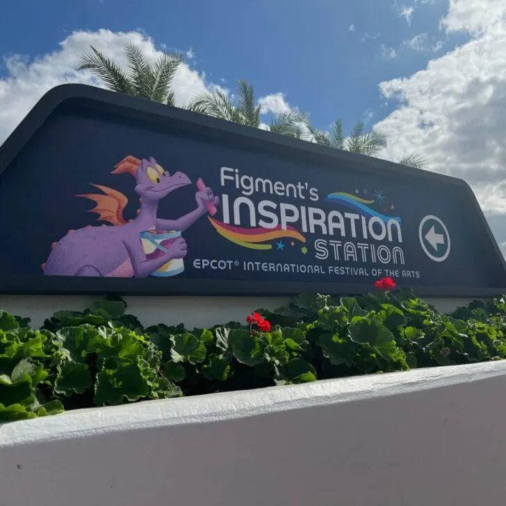 Photo of signage for Figment's Inspiration Station at Epcot, with an image of Figment the purple dragon.