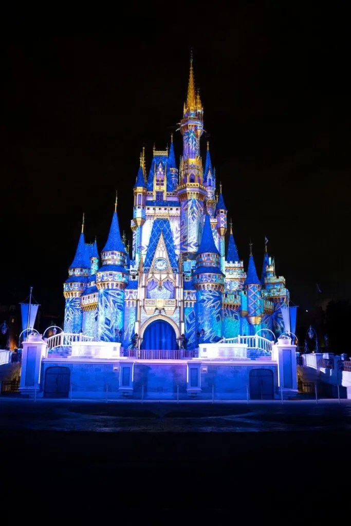 Photo of Cinderella's Castle during the Frozen Holiday Surprise nighttime show at Magic Kingdom.