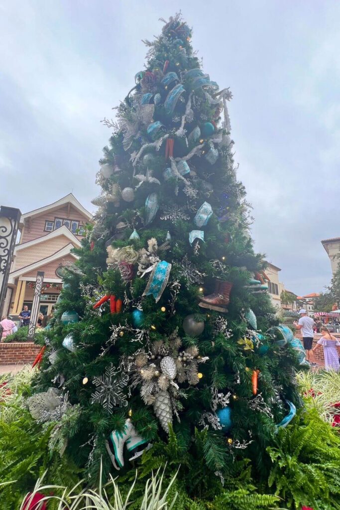 Photo of a Frozen themed Christmas tree with turquoise ribbons and silver accents.