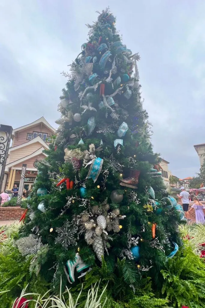 Photo of a Frozen themed Christmas tree with turquoise ribbons and silver accents.