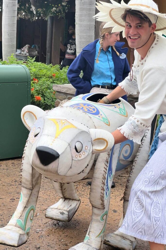 Photo of a polar bear puppet and its handler from Merry Menagerie at Disney's Animal KIngdom.