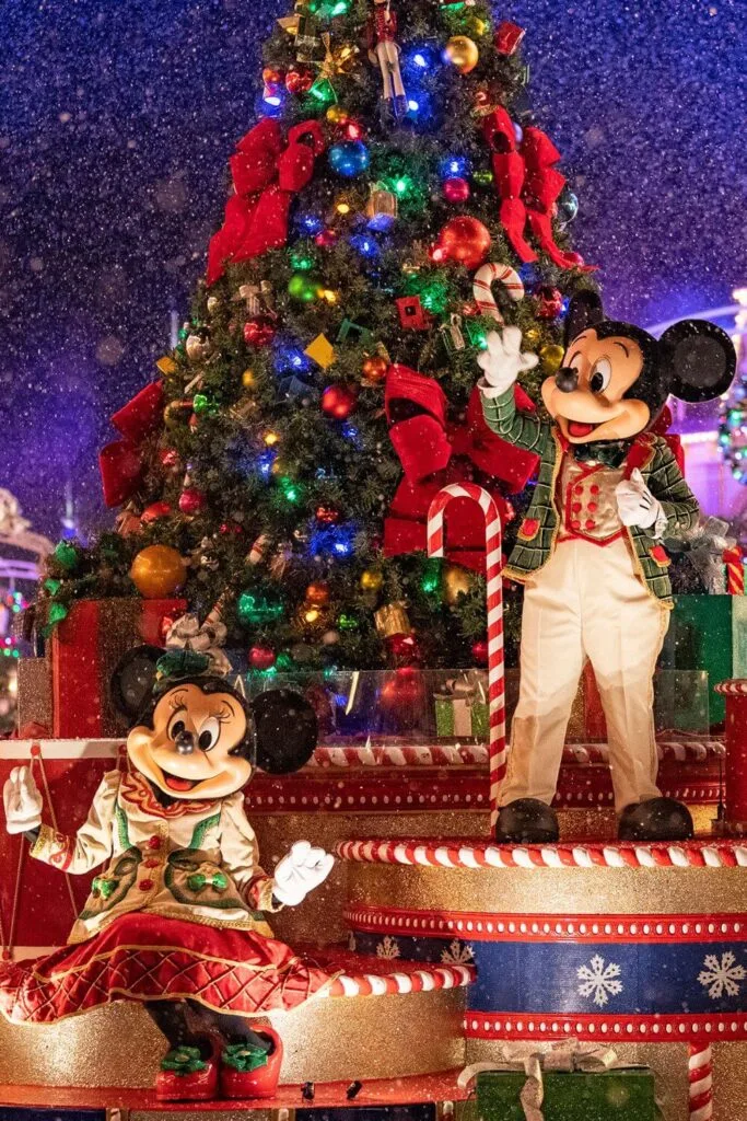 Photo of Mickey and Minnie Mouse on a float during Mickey's Once Upon a Christmastime Parade during Mickey's Very Merry Christmas Party while "snoap" is falling.