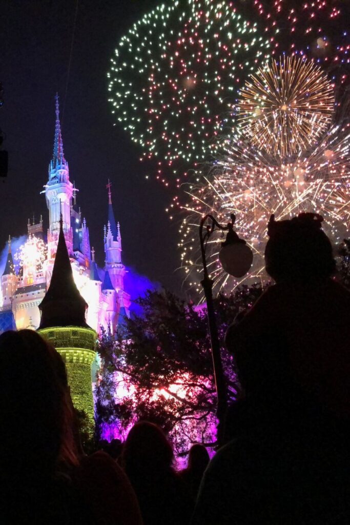 Photo of fireworks from Minnie's Wonderful Christmastime Fireworks bursting behind Cinderella's Castle at Magic Kingdom.