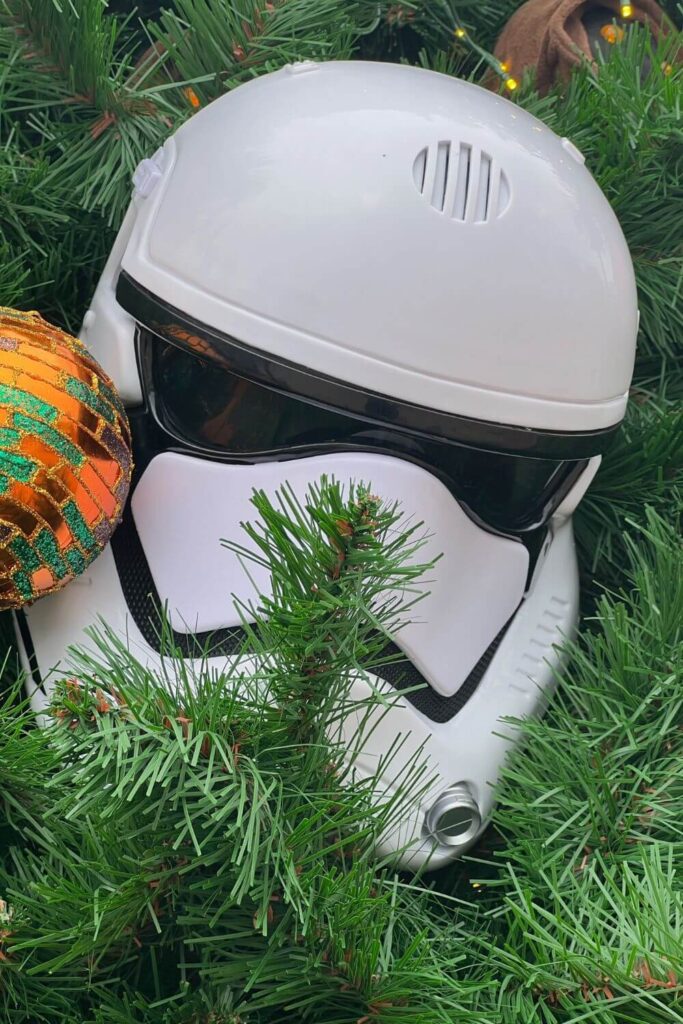 Closeup of a Star Wars stormtrooper helmet ornament on a Christmas tree in Disney Springs.