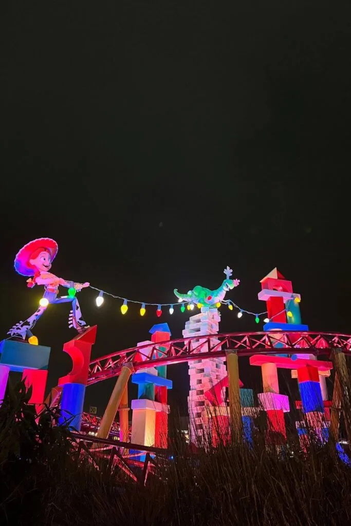 Photo of Jessie and reindeer Rex setting up Christmas lights on Slinky Dog Dash at Hollywood Studios' Toy Story Land.