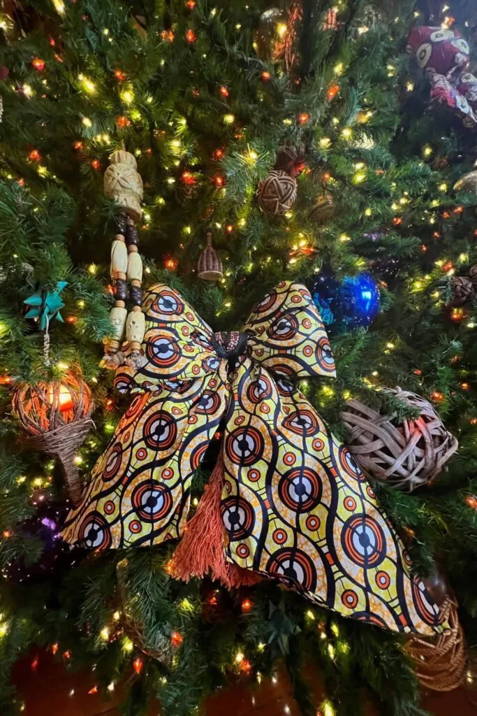 Closeup of a yellow and orange African print bow on a Christmas tree at Disney's Animal Kingdom Lodge.