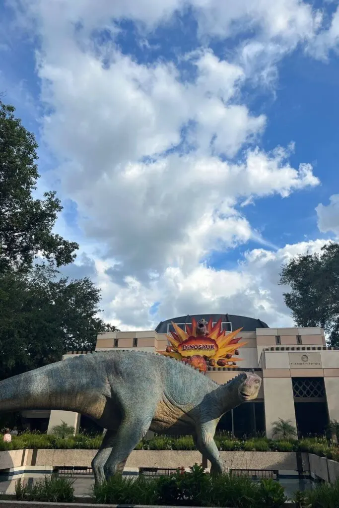 Photo of the entrance of Dinosaur at Animal Kingdom, with a large dinosaur statue out front.