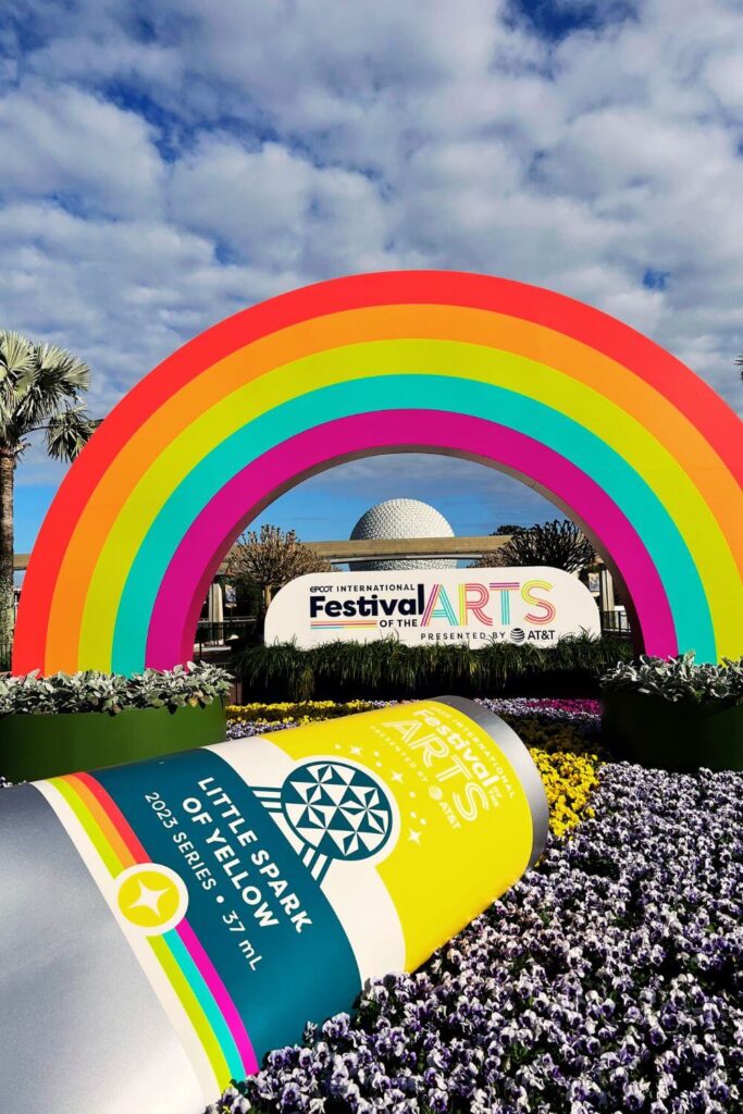 Photo of the arts display at Epcot featuring a gigantic tube of paint, a rainbow and Spaceship Earth in the background.