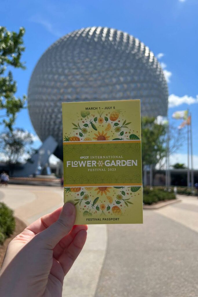 Photo of the passport for the Epcot International Flower & Garden Festival with Spaceship Earth in the background.