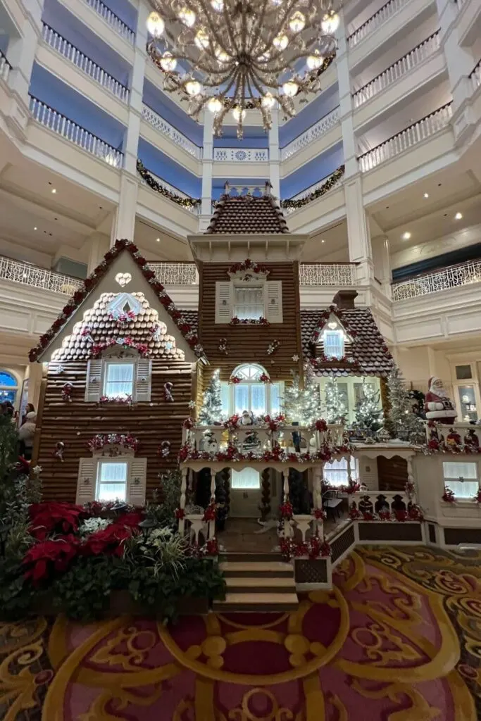 Photo of the 2023 Grand Floridian gingerbread house, with the resort lobby in the background.