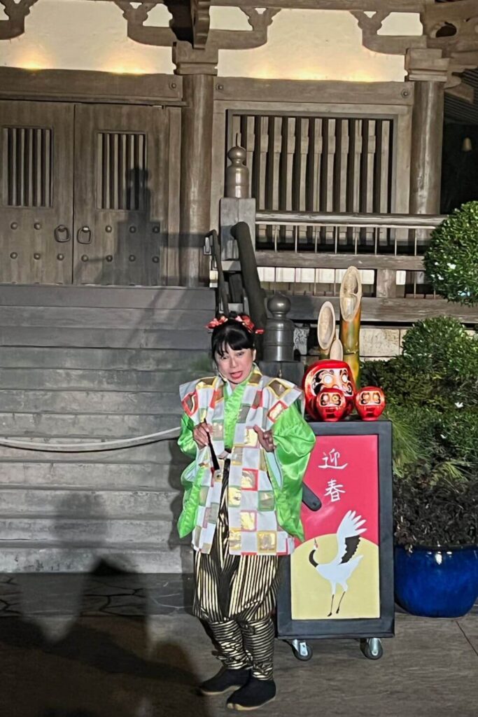 Photo of a storyteller telling the story of the Daruma doll at Epcot's Japan pavilion.