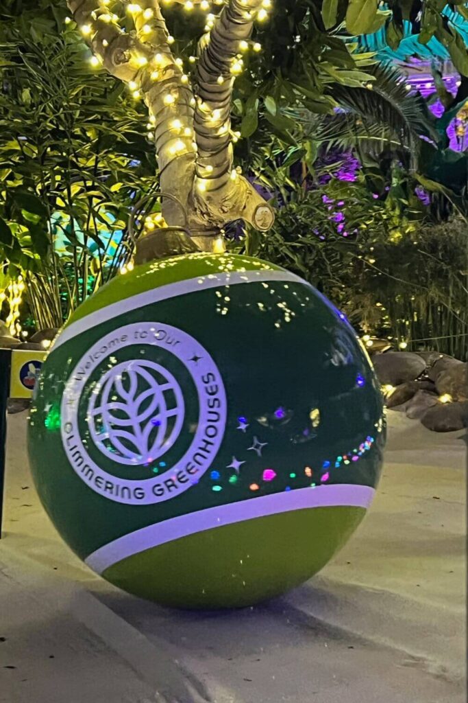 Photo of a giant Christmas bulb with an Epcot icon on it.
