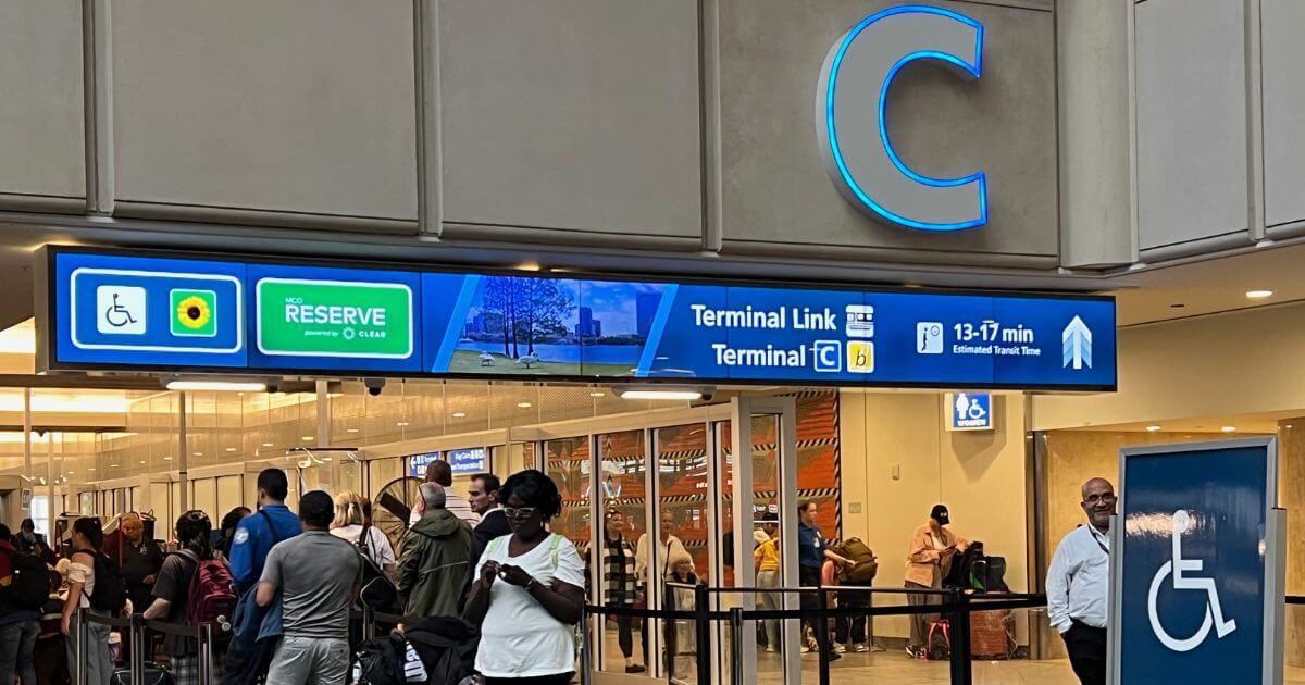 Closeup of the signage for MCO Reserve at the terminal security checkpoint at Orlando Airport.