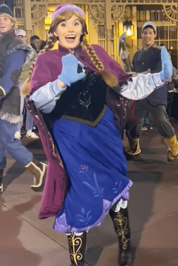 Photo of Anna from Frozen, dancing in a parade at Disney World.