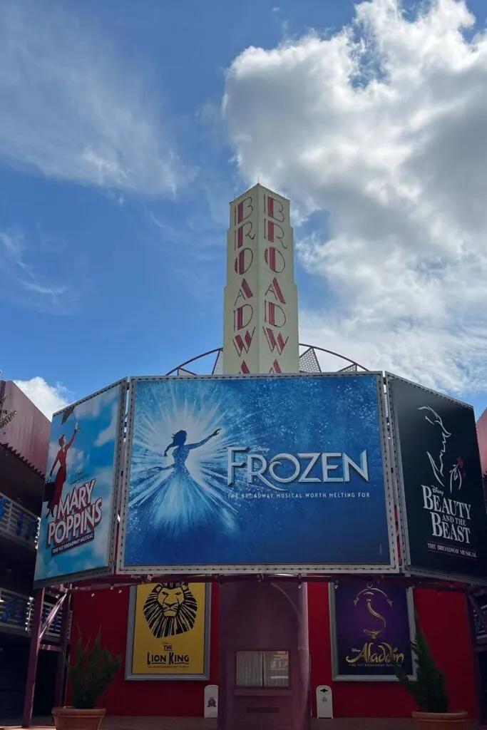 Photo of faux broadway advertisements on a hotel building, featuring Mary Poppins, Frozen, Beauty & the Beast, The Lion King, and Aladdin.