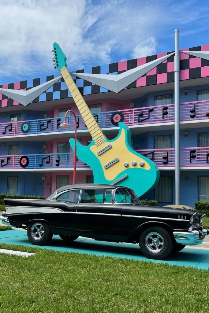 Photo of one of many photo ops at the All Star Music Resort, featuring a vintage car with a giant guitar in the background.