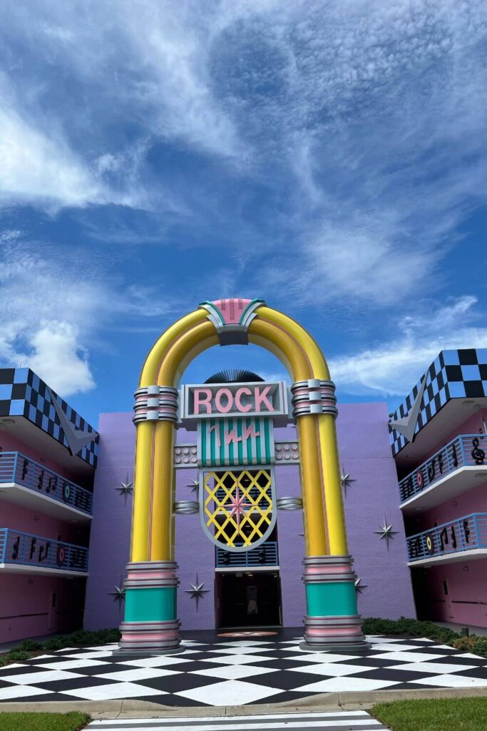 Photo of a giant jukebox-like arch at a hotel. On the arch, text reads: Rock Inn.