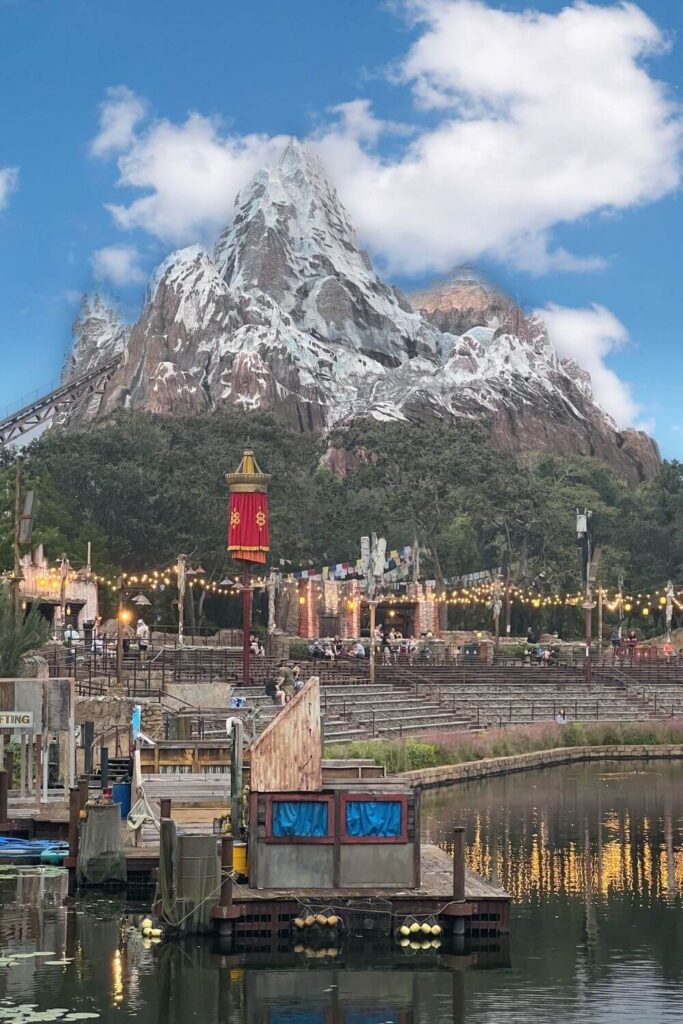Photo of Expedition Everest with cloudy skies with the lagoon theater in the foreground.