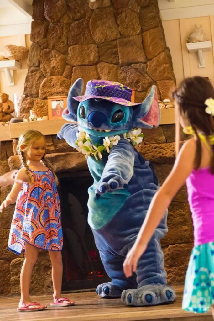 Photo of Stitch teaching kids how to pretend surf at Aunty's Beach House.