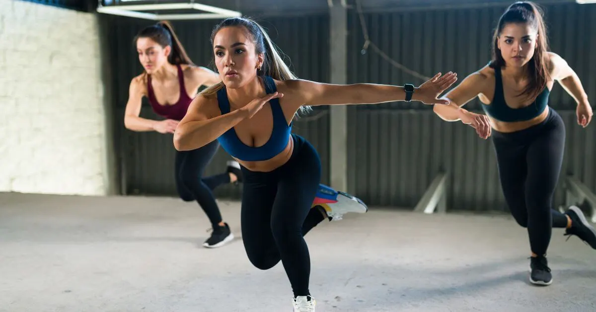 Photo of a group of 3 women doing a cardio workout.