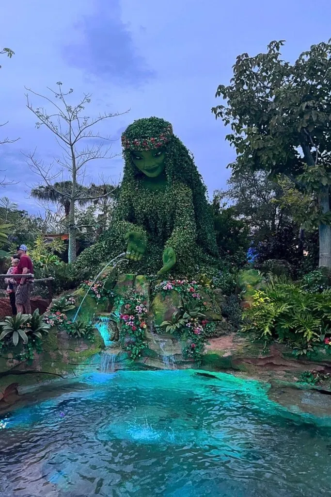 Photo of Te Fiti looking over a pond at Epcot's Journey of Water walk-through attraction.