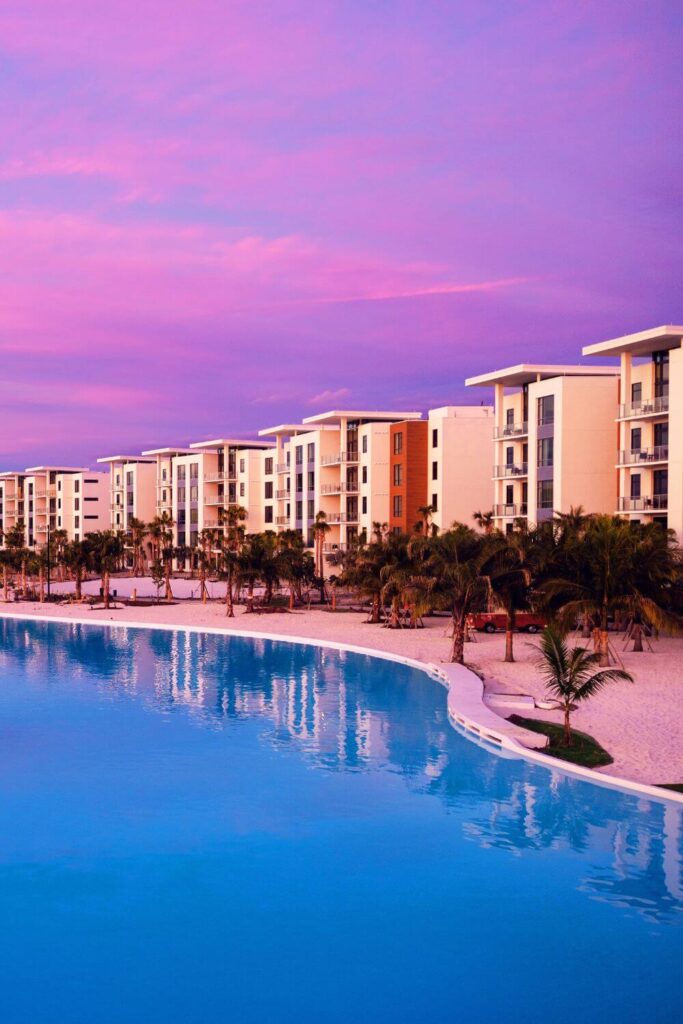 Photo of Evermore Resort Orlando flats along the lagoon with purple and pink skies.