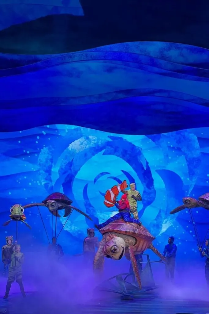 Photo from a scene in the Finding Nemo stage show at Animal Kingdom featuring Crush, Squirt, Nemo and other characters.